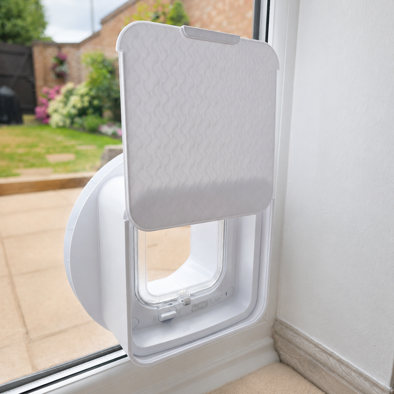 Purrfect Prints deeper sliding cover fitted to a SureFlap DualScan Microchip Cat Flap